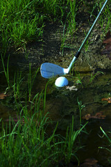 Man chipping ball from water hazard
