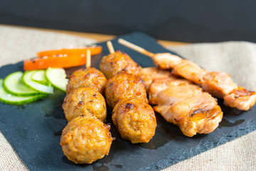 tasty beef steak kabobs with vegetables on a slate plate
