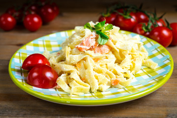 tasty pasta with salmon on a the table