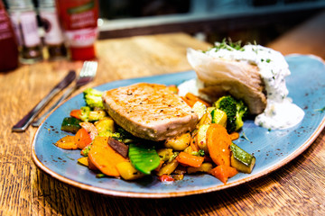 french cuisine dish with vegetables and salmon