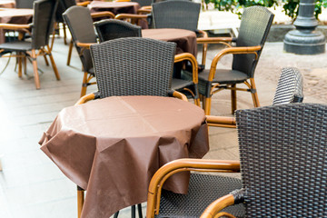Street view of a coffee terrace with tables and chairs in europe