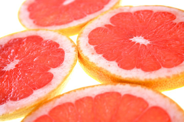 Closeup of sliced grapefruit on white background