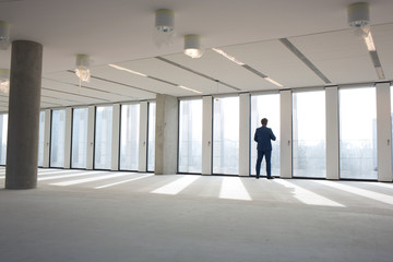 Fototapeta na wymiar Rear view of mature businessman visiting empty office space
