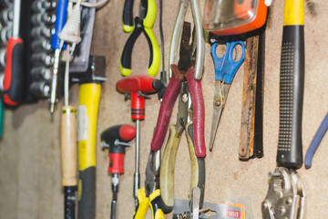 Car Repair Tools. different old tools hanging on wooden wall.