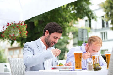 Fototapeta na wymiar Businessmen eating food at outdoor restaurant