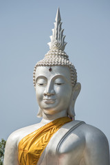The White buddha status on blue sky background , Thailand
