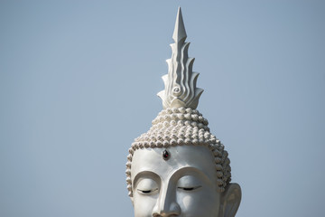Fototapeta na wymiar The White buddha status on blue sky background , Thailand