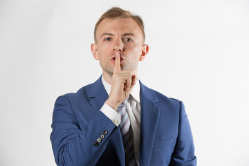 Businessman with finger over lips