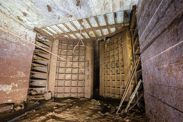 Abandoned old ore mine shaft tunnel passage with gate