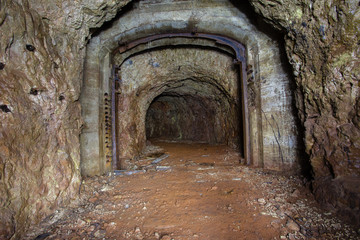 Fototapeta na wymiar Abandoned old ore mine shaft tunnel passage