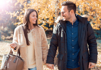 Loving couple on dating in autumn park. Love and romance.