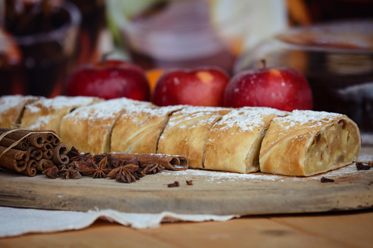 Apple strudel with fresh apples, anason and cinnamon on a wooden board 