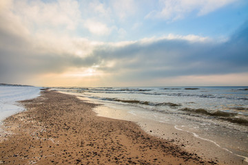 The rays of the sun in winter beach, snowy landscape