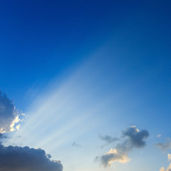 Naklejka na ściany i meble light rays on clear blue sky background