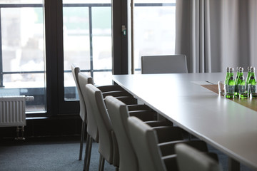Chairs at conference table in modern office