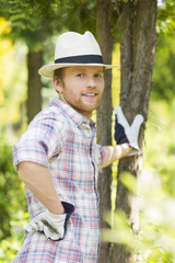 Portrait of confident gardener standing at plant nursery