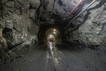 Copper mine shaft tunnel passage with machines and pipes