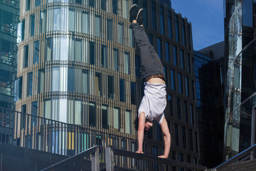 Young man doing handstand in the city