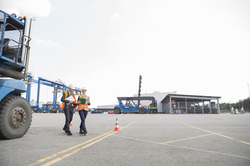 Full-length of workers walking in shipping yard