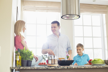 Family preparing food in kitchen