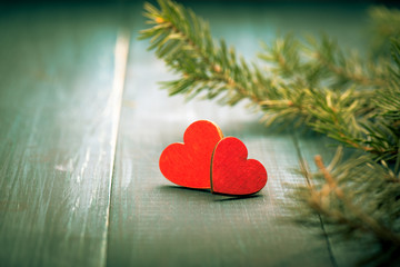 Two red wooden hearts on green table. Christmas decoration. Copy space. Valentine. Love.