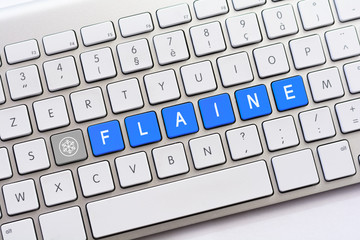 FLAINE writing on white keyboard with a snowflake sketch