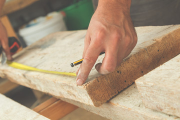 Carpenter working on raw wood.