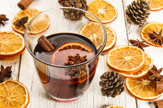 mulled wine and christmas decoration on an old rustic white tabl