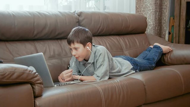 Little boy watching video on the laptop computer