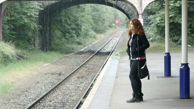 young woman waiting the train on the platform
