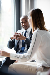 Young businessman with female colleague in office cafeteria