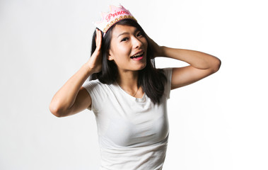 Fototapeta na wymiar Chinese woman having fun with a princess crown 