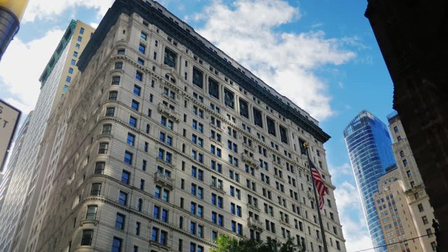 Office building with the American flag. Wall Street, New York