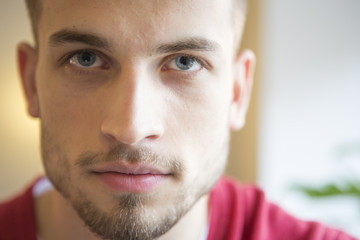 Close-up portrait of confident man in cafe