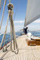 Man working on prow of yacht