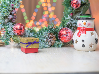 Christmas decorations and gifts with blurry lights in the background.