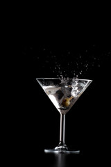 Splash in mrtini glass on black background