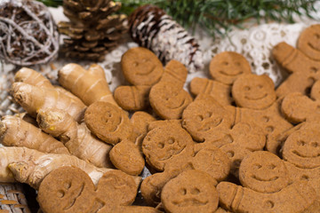 Many Christmas smiling  gingerbread men on white lace