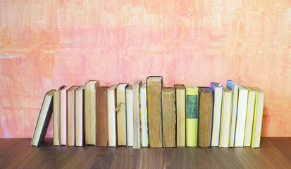 row of old books on grungy background, good copy space