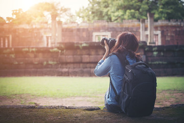 Young attractive woman photographer tourist with backpack.