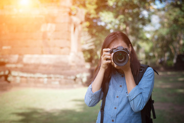 Young attractive woman photographer tourist with backpack.