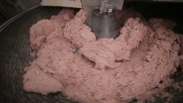 Industrial production of minced meat. Minced meat processing machine working at mear factory. HD.