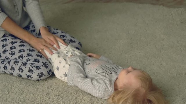 Mother plays with daughter on the floor