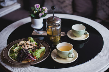  Salad and Hot Tea with cups on the table