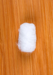 White cotton balls isolated on wood background