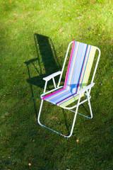 garden chair on green lawn background