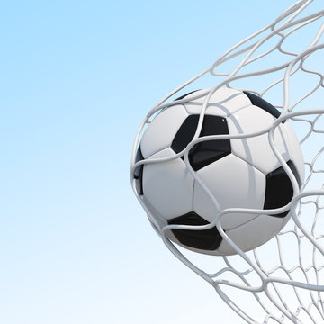 Soccer ball in net on sky background.
