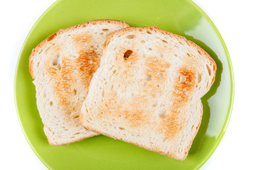 Two whole grain slices of bread toasted on a ceramic plate isolated on white background