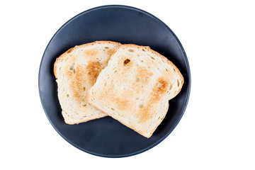 Two whole grain slices of bread toasted on a ceramic plate isolated on white background