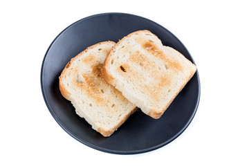 Two whole grain slices of bread toasted on a ceramic plate isolated on white background